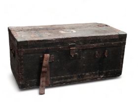 An early 20th century car trunk - covered in black oilcloth with steel banding and brass corners,