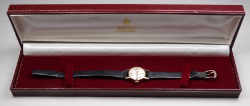 A 9ct gold cased ladies wristwatch by Garrard & Co - the silvered dial with baton numerals, with a