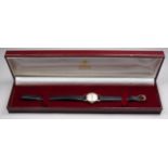 A 9ct gold cased ladies wristwatch by Garrard & Co - the silvered dial with baton numerals, with a