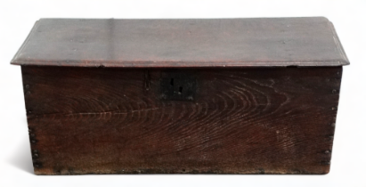 A late 17th century small six plank oak boarded coffer - the rectangluar top with moulded edge above