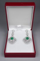 A pair of large 18ct white gold emerald and diamond set drop earrings - the central oval emeralds