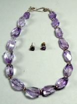 An amethyst necklace - of asymetrical faceted beads with silver mounts, length 44cm, together with a