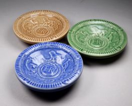 A set of three Wade coronation dishes - 1953, with low relief decoration in differing colourways.