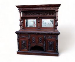 An impressive Victorian oak Jacobean Revival style sideboard - the raised mirrored back with leaf