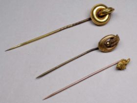 A gilt metal stock pin - in the form of a knot, together with two further gilt stock pins, weight