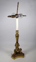 A brass Italian style table lamp - of baluster form, with tripod base and with claw feet, height