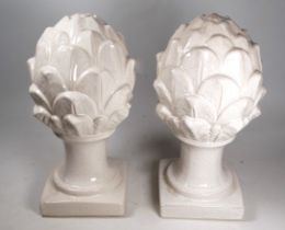 A pair of contemporary white glazed pineapple finials - raised on a square base, height 31cm.