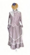 A re-enactment dress - in the form of a mid 19th century American woman, lilac satin, including