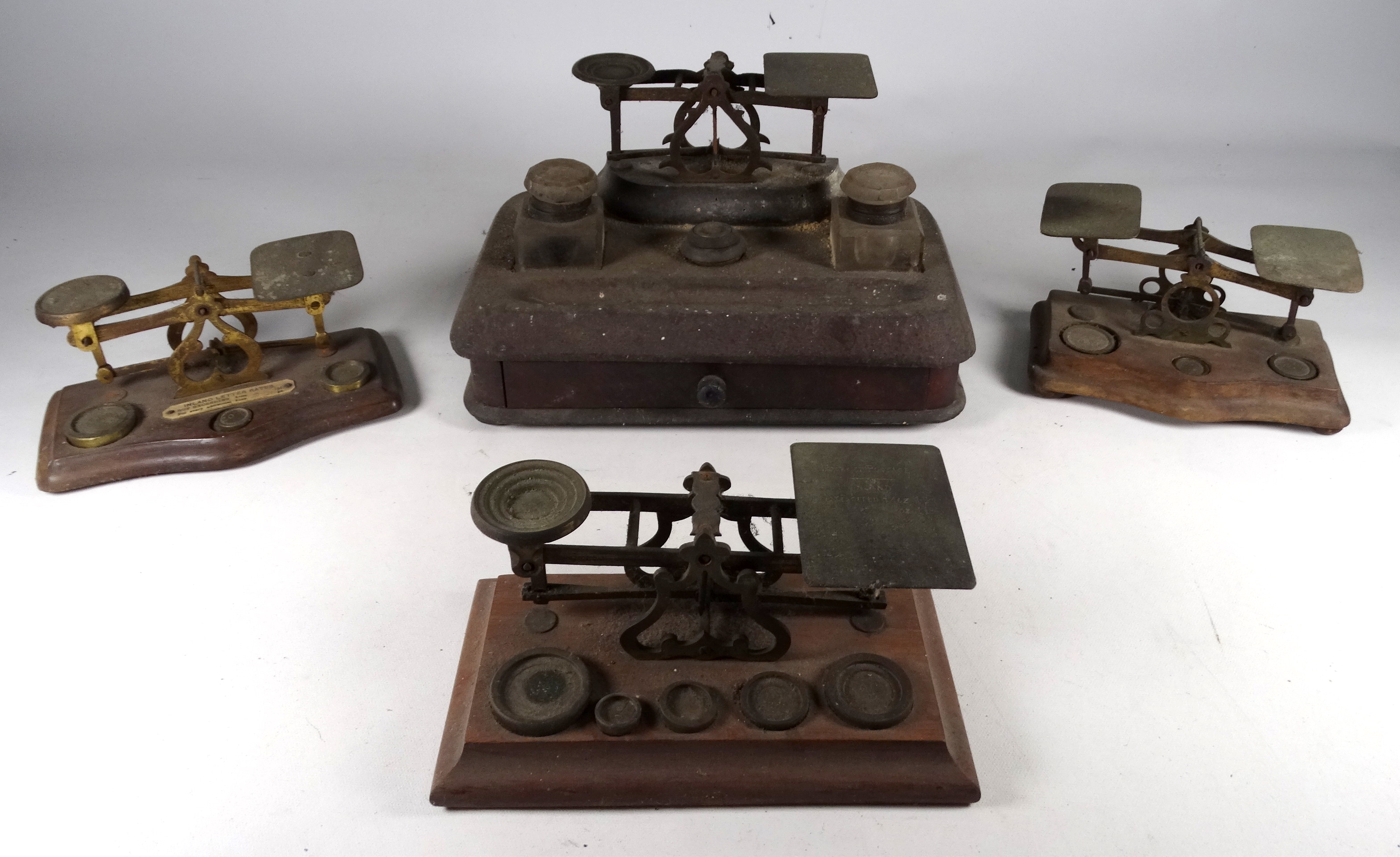 An early 20th century mahogany standish - incorporating a pair of glass inkwells, a drawer and a set