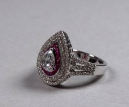 An 18ct white gold diamond and ruby set ring - the central pear shaped rose cut diamond weighing 0.