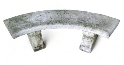 A 20th century reconstituted stone bench - semi-circular, the solid seat raised on scrolled