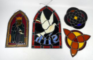 A 20th century stained glass panel - lancet shaped, depicting a seated king, together with three