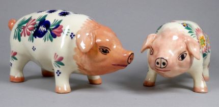 A Quimper pottery piggy bank - decorated with flowers, width 21cm, together with another Quimper