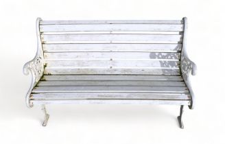 A 20th century cast iron and hardwood slatted bench - cream painted, with pierced end supports