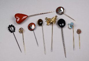 A small quantity of base metal stock pins - including a cabochon tiger's eye, Whitby jet, gilt and