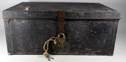 A black painted tin trunk - rectangular with bail handles, the lid with a luggage label, fitted with