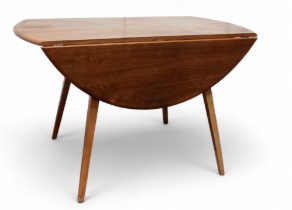 An Ercol elm and beech oval drop leaf Windsor dining table - model 384, with splayed tapered