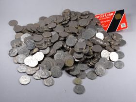 A quantity of fifty pence pieces - mosty 1975 commemorative, together a quantity of pound coins