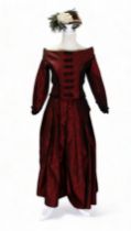 A re-enactment dress - in the form of a mid 19th century American woman, red satin with black