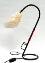 After Jacques Adnet (1900-1984) a snake desk lamp - wrought steel with a tan leather band, fitted