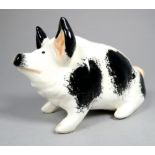 A Wemyss Griselda Hill pottery pig - seated, decorated with black spots, width 18cm.