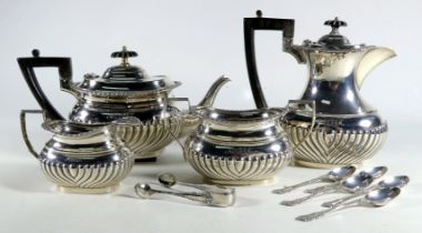 A silver four piece tea service - Sheffield 1894, part gadrooned with ebonised fittings,