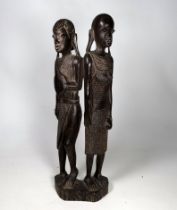 A carved African hardwood figural group - one figure holding a shield, height 39cm.