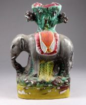 A 19th century Staffordshire flatback spill vase - modelled in the form of an elephant, height