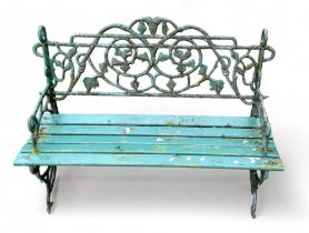 A 20th century cast iron garden bench - painted green, with wrythen end supports and back, with a