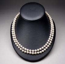A string of faux pearls with 9ct clasp - comprising twin strands of uniform faux pearls.