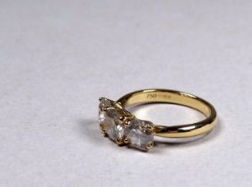 An 18ct yellow gold diamond three stone ring - the circular brilliant cut diamonds weighing 2.