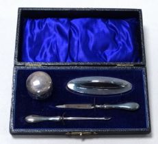 A silver mounted manicure set - Birmingham 1921, the boxed set comprising four items.