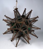 A North African lightshade - steel and coloured glass of geometric form with cones, height 42cm.