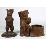 An early 20th century Black Forest bear - seated with a pipe beside a pin dish, stamped 'Aeschi',