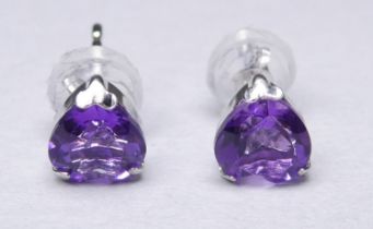 A pair of platinum ear studs set with heart shaped amethyst - with platinum rubber coated