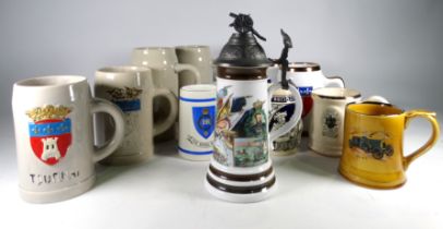 A pewter lidded German stein - the cover modelled with an artillery gun, together with eleven