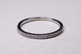 A platinum diamond half hoop eternity ring - claw set, size S/T, weight 2.7g.