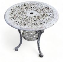 A cast iron circular garden table - white painted, the top decorated with foliage and