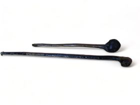 A 19th century club modelled with a gentlemans face - length 61cm, together with another.