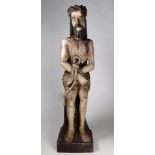 A carved polychrome figure of a bound man - height 50cm.