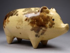 A 19th century pottery piggy bank - sponge decorated on a cream ground, width 13cm.