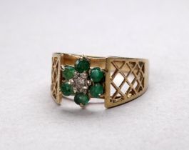 A 9ct gold emerald and diamond set ring - of foliate design with pierced shoulders, size J, weight
