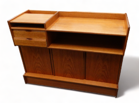 A Turnidge of London teak sideboard - of asymmetrical form, including cubby holes, drawers and