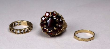A 9ct gold garnet cluster ring - claw set with a pierced textured mount, together with two further