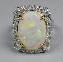 An 18ct white and yellow gold ring set opal and diamonds - the central oval opal weighing 3.96ct