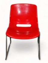 Svante Schoblon for Overman - a red moulded plastic stacking chair, raised on tubular chrome metal