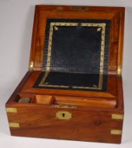 A Victorian walnut writing slope - with a vacant cartouche and brass binding, the interior with