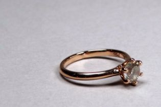 An 18ct rose gold diamond solitaire ring - the brilliant cut diamond weighing 0.91ct