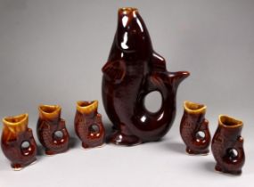 A 20th century treacle glazed glug jug - height 21cm, together with five smaller jugs.