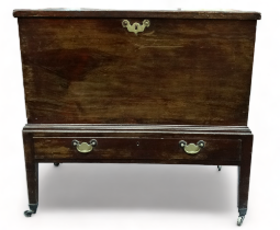 A 19th century mahogany trunk - with rectangular top and brass bale handles on a low stand with